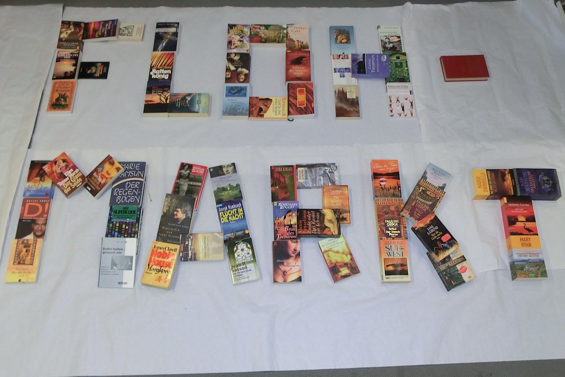 Das Bild zeigt das Wort "Flohmarkt", gelegt aus Büchern.