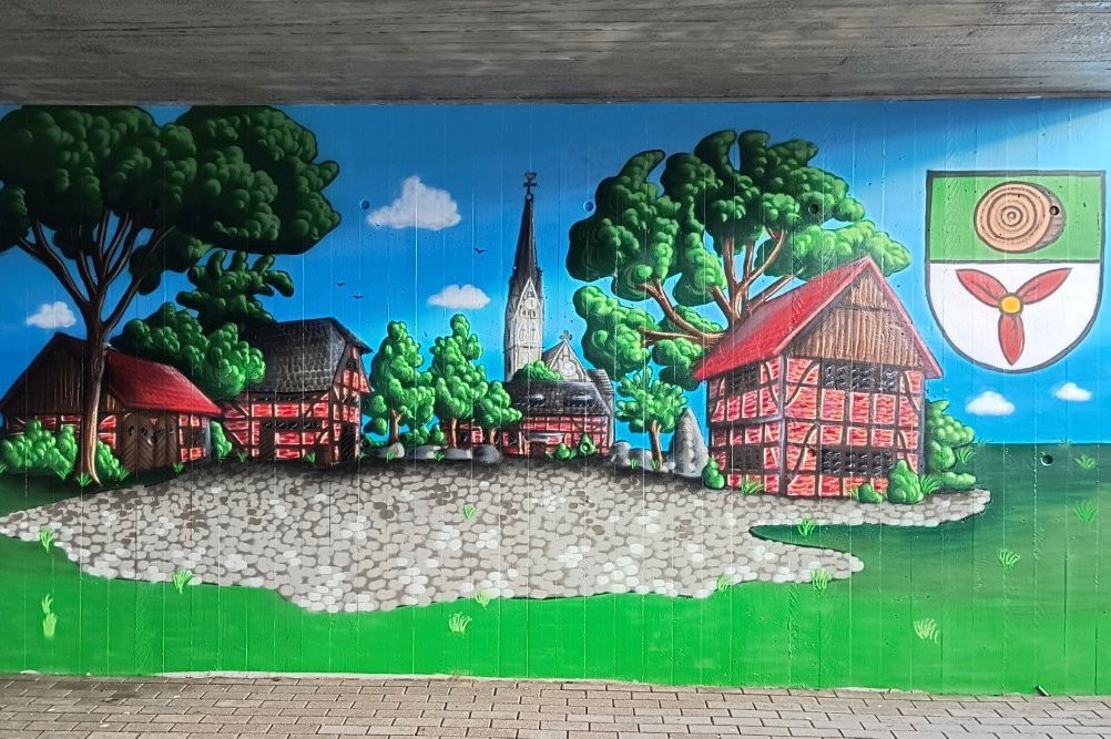 Das Bild zeigt ein Grafitti mit Ortsansichten von Buldern.